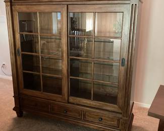 $500 Curio cabinet with glass shelves, lights and sliding glass doors.  Also has drawers on top and bottom of piece.  (W 52" x H 55" x  18" contact to confirm measurements.) 