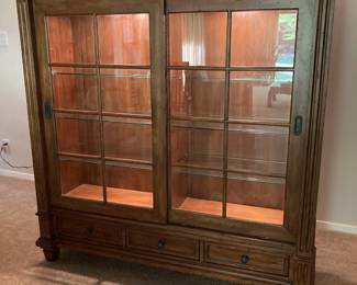 $500 Curio cabinet with glass shelves, lights and sliding glass doors.  Also has drawers on top and bottom of piece.  (W 52" x H 55" x  18" contact to confirm measurements.) 