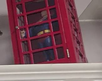 Red telephone booth with superman figurine, table top size
