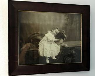 Framed picture of girl and dog.