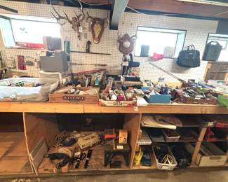 Large quantity of tools, mounted deer antlers, woodworking equipment.