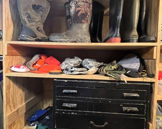 Variety of boots, hunting clothes, black wood chest w/drawers.