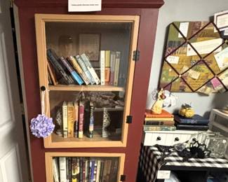 Amish made cabinet filled with books.