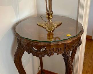 The table has four legs and comes with a glass top.  The lamp has three legs and may or may not have a glass top.