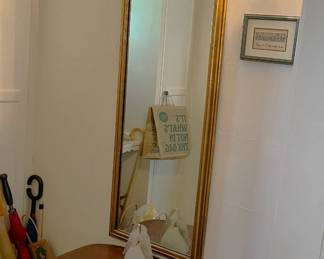 This wall-mounted mirror will provide you years of reflections.  And the small table below it is quite useful, too.