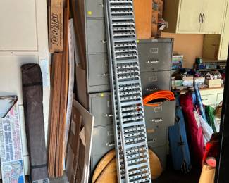 Behind the two truck-tailgate wheel ramps are two metal filing cabinets, and another filing cabinet on the other side.  My question is "what are those flat wood pieces in front of the filing cabinets?"