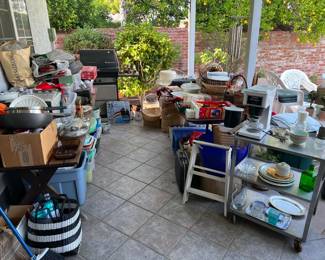 With this image we begin looking at the garage and patio items.  You'll see here there is quite the mix of kitchen appliances, rolling carts, barbeques, and cooking utensils.