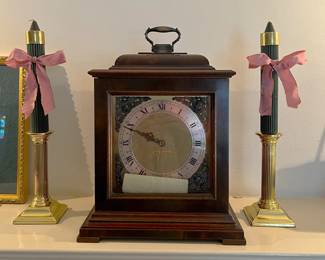 Here we have a mantel clock and two decorative, matching black candles with holders.