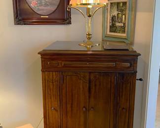 This is the Victrola phonograph player, along with the lamp and a few framed art pieces on the wall behind.
