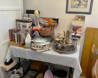On this table are a number of kitchen appliances: a vacuum sealer, a Hamilton Beach mixer, a silver tea set, a Mr. Coffee, an ice bucket...all the fun stuff!