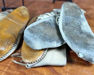 This lot features a pair of what appear to be antique Native American moccasins, consistent with styles produced in the 19th century by Plains tribes.