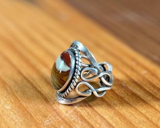 This lot features a beautiful handmade ring crafted from sterling silver with a Jasper center stone in a size 7.