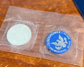 This lot features a 1971 Eisenhower uncirculated silver dollar in the original packaging.