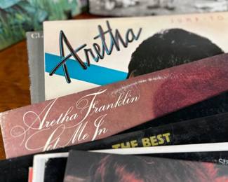 This lot features a large collection of twenty-six (26) vinyl records including artists Barbara Streisand, Aretha Franklin, Ray Charles, George Harrison, and many others.