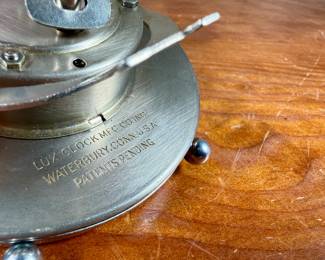 This lot features a vintage mechanical desk clock manufactured by Lux in good working condition.