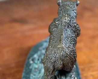 This lot features a bronze bear sculpture on a stone plinth by SPI Gallery. Signed as shown in photos and measures, 7” H x 10” W x 5” D.