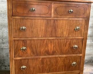 This lot features an antique highboy chest of drawers, crafted with solid wood and dove-tailed drawers. Two smaller drawers up top and three larger below. This dresser measures, 43” H x 34” W x 19.5” D.