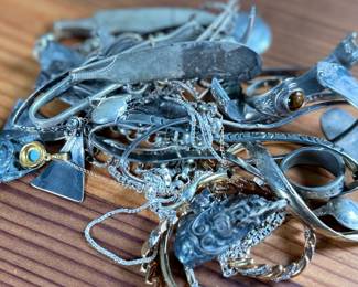 This lot features a large collection of sterling silver jewelry and scrap with a total approx. weight of 256.44 grams.