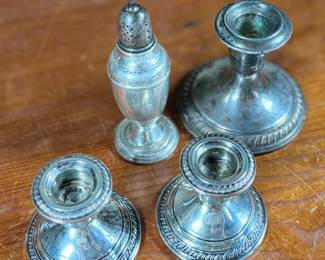 This lot features a collection of four (4) antique weighted sterling silver items with a total approx. weight of 700.00 grams.