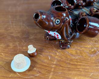 This lot features a vintage dachshund-shaped ceramic decanter set, often referred to as a "drunken dog" liquor flask set. In excellent condition and measures, 5” H x 13” W x 7” D.