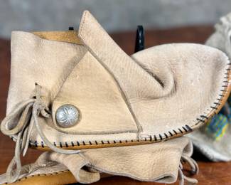 This lot features a pair of what appear to be antique Native American moccasins, consistent with styles produced in the 19th century by Plains tribes.