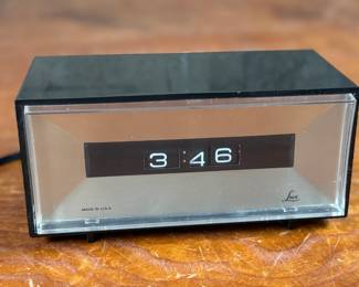 This lot features a vintage Lux electric flip clock circa 1970s in good working condition.