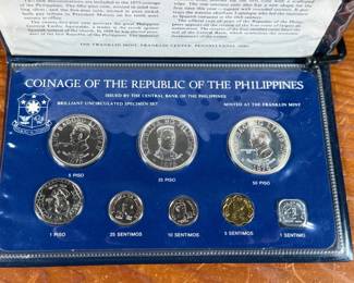 This lot features a 1975 Republic of the Philippines 8-coin specimen set produced by the Franklin Mint. This proof set was issued by the Central Bank of the Philippines and includes denominations from the 1 Sentimo up to the 50 Piso. The set features 1.2166 troy ounces of silver in the higher denomination coins. It includes a square-shaped 1 Sentimo coin and commemorates the “New Society” movement.
