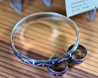 This lot features a set of handcrafted sterling silver & lapis lazuli inlay jewelry including a bracelet and a pair of earrings. Originally purchased from Lapis Box in Vancouver, BC with the original box and papers.