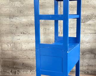 This lot features a two (2) piece wooden book or bar cart on casters with a fold down shelf. This cabinet measures, 65” H x 29.5” W x 19.5” D. Small crack that could be repaired on a caster as shown in photos.