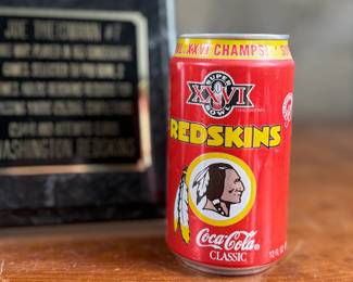 This lot features a commemorative picture plaque of Joe Theismann with an autograph on the left photograph and a card on the right. The plaque measures, 12” H x 15” W. This lot also comes with a rare 1992 Coca-Cola souvenir can commemorating the Washington Redskins’ victory in Super Bowl XXVI in excellent condition.