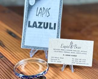 This lot features a set of handcrafted sterling silver & lapis lazuli inlay jewelry including a bracelet and a pair of earrings. Originally purchased from Lapis Box in Vancouver, BC with the original box and papers.
