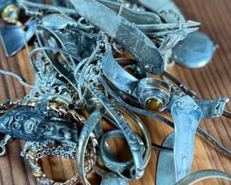 This lot features a large collection of sterling silver jewelry and scrap with a total approx. weight of 256.44 grams.