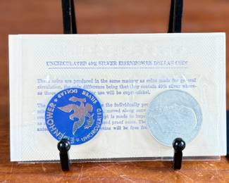 This lot features a 1971 Eisenhower uncirculated silver dollar in the original packaging.