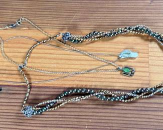 This lot features three (3) sterling silver necklaces with pieces including jade, pearls, and more. Total approx. weight of 46.91 grams.