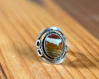 This lot features a beautiful handmade ring crafted from sterling silver with a Jasper center stone in a size 7.