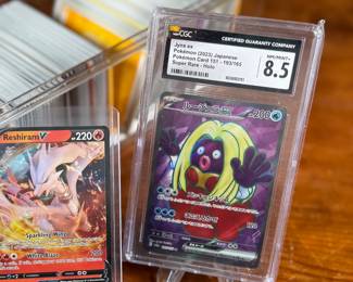 This lot features a large Pokemon trading card game collection including tons of holos, a graded 2023 Pokemon Jynx EX from the 151 set by CGC, and some Japanese/Korean cards.