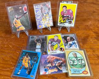 This lot features a collection of sports cards in various conditions. Some athletes include Kobe Bryant, Pat Richter, Emerson Boozer, and others. Some appear to be signed.