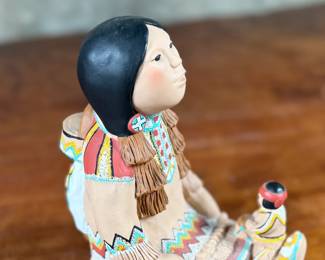 This lot features an Indian storyteller sculpture by listed artist, Cleo Teissedre circa 1990s. This sculpture measures, 6.5” H.