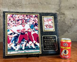 This lot features a commemorative picture plaque of Joe Theismann with an autograph on the left photograph and a card on the right. The plaque measures, 12” H x 15” W. This lot also comes with a rare 1992 Coca-Cola souvenir can commemorating the Washington Redskins’ victory in Super Bowl XXVI in excellent condition.