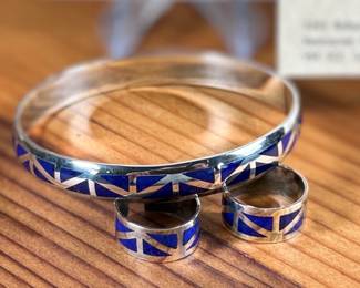 This lot features a set of handcrafted sterling silver & lapis lazuli inlay jewelry including a bracelet and a pair of earrings. Originally purchased from Lapis Box in Vancouver, BC with the original box and papers.