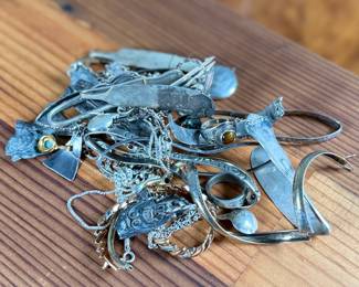 This lot features a large collection of sterling silver jewelry and scrap with a total approx. weight of 256.44 grams.