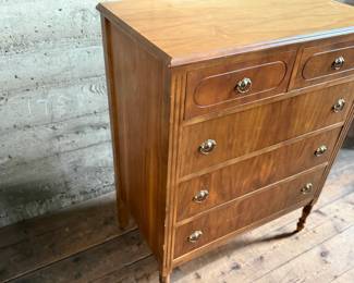 This lot features an antique highboy chest of drawers, crafted with solid wood and dove-tailed drawers. Two smaller drawers up top and three larger below. This dresser measures, 43” H x 34” W x 19.5” D.