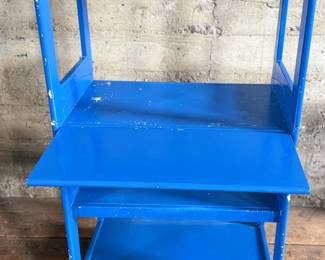 This lot features a two (2) piece wooden book or bar cart on casters with a fold down shelf. This cabinet measures, 65” H x 29.5” W x 19.5” D. Small crack that could be repaired on a caster as shown in photos.