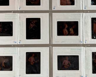 Vintage 35mm slides primarily organized in a transparent holder. Each slide features labels with the name “Richard Creamer” and addresses in Beverly Hills and Los Angeles, CA. Subjects documented include notable music acts that are believed to be Steve Winwood, Donna Summer, and others.