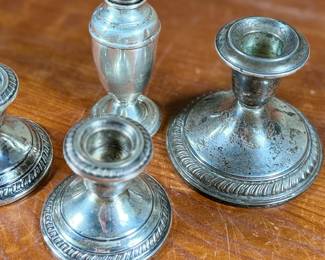 This lot features a collection of four (4) antique weighted sterling silver items with a total approx. weight of 700.00 grams.