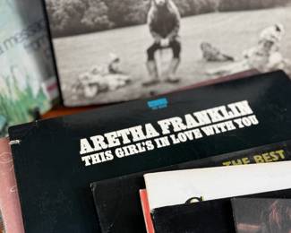 This lot features a large collection of twenty-six (26) vinyl records including artists Barbara Streisand, Aretha Franklin, Ray Charles, George Harrison, and many others.