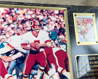 This lot features a commemorative picture plaque of Joe Theismann with an autograph on the left photograph and a card on the right. The plaque measures, 12” H x 15” W. This lot also comes with a rare 1992 Coca-Cola souvenir can commemorating the Washington Redskins’ victory in Super Bowl XXVI in excellent condition.