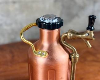This lot features a GrowlerWerks uKeg pressurized beer growler in a copper finish. Works as it should and is in good overall condition.