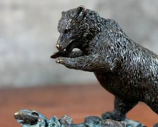 This lot features a bronze bear sculpture on a stone plinth by SPI Gallery. Signed as shown in photos and measures, 7” H x 10” W x 5” D.
