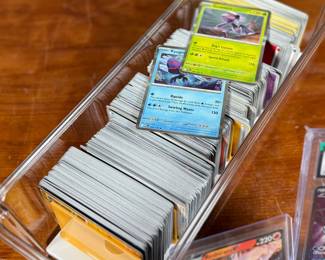 This lot features a large Pokemon trading card game collection including tons of holos, a graded 2023 Pokemon Jynx EX from the 151 set by CGC, and some Japanese/Korean cards.